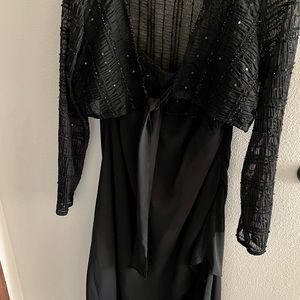 Black dress with slip, laying length, and sparkle cardigan.